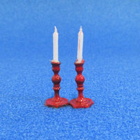 2 røde lysestager m.lys